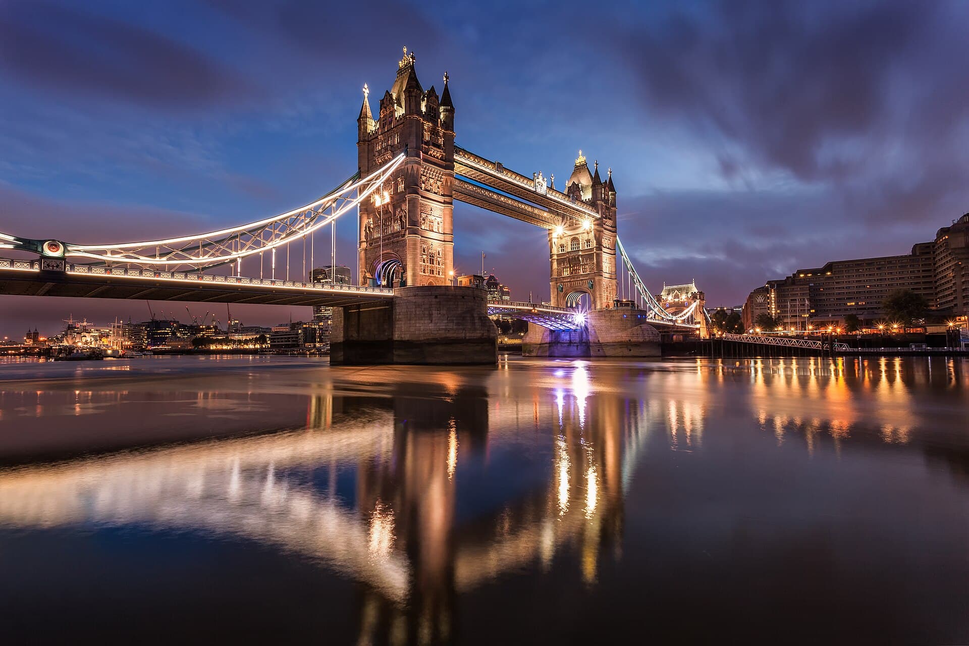 Tower Bridge lit up at dawn over the Thames
