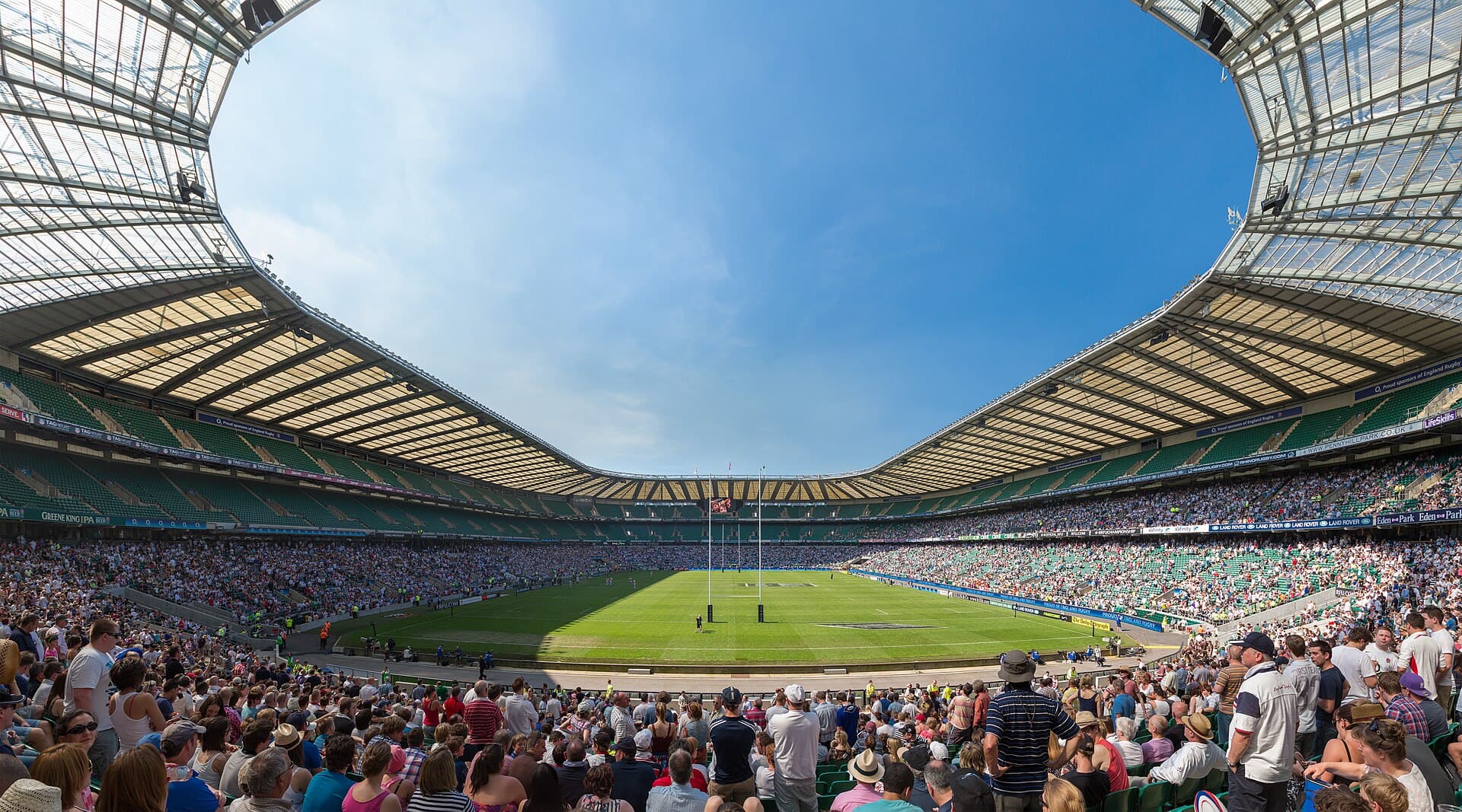 Twickenham Stadium full of fans under a blue sky